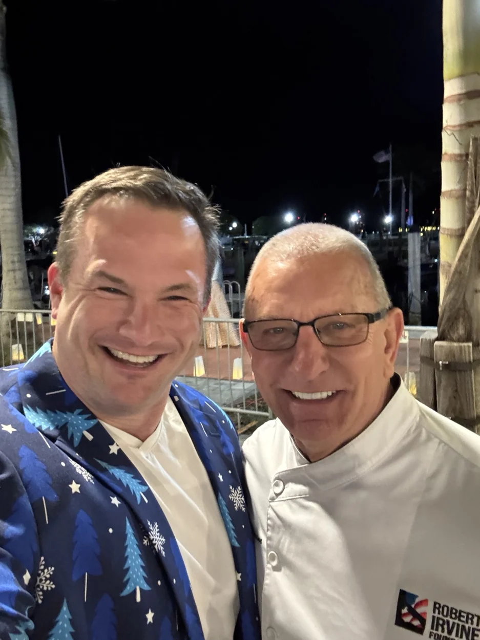 Two attendees smiling at an outdoor food event