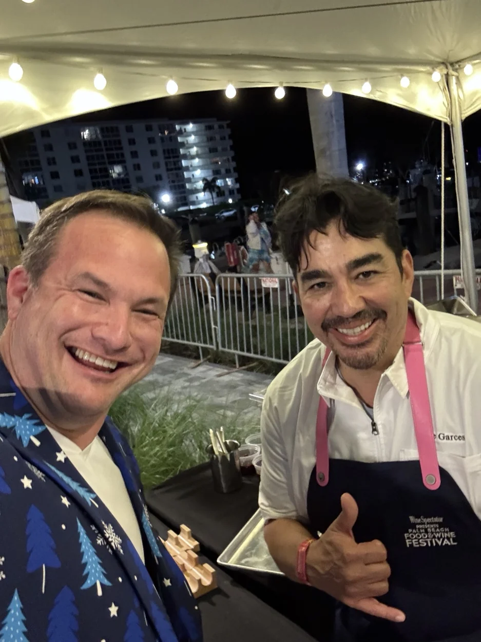 A festival attendee and a chef under an event tent
